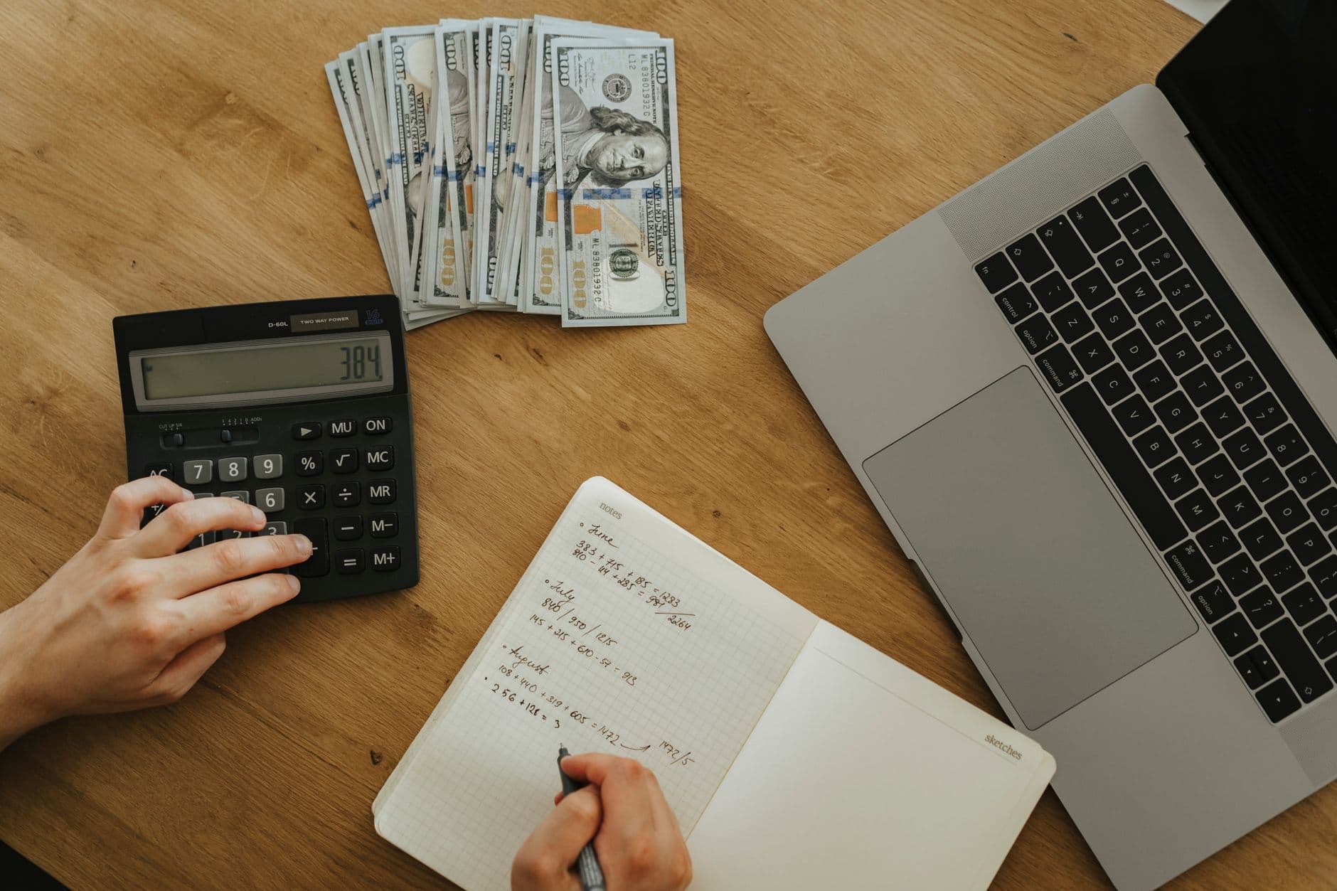 Using a calculator and notebook to plan hosting finances