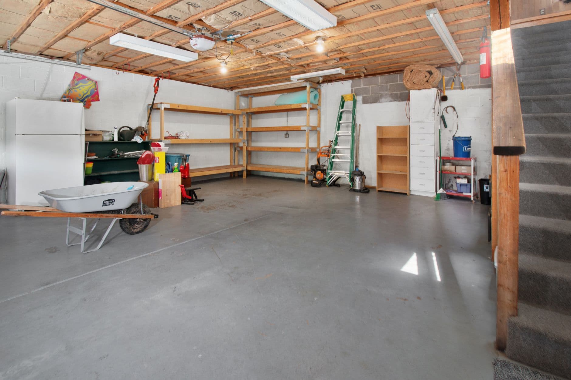 Spacious garage interior with storage shelves and equipment, the kind of idle space that can earn storage income