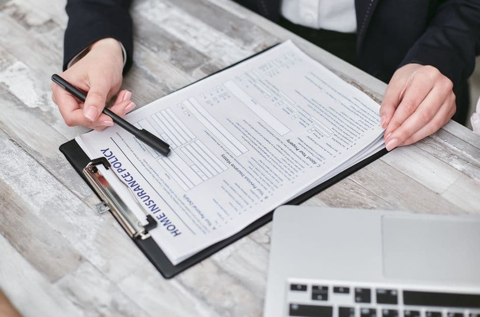 Hands reviewing a home insurance policy document