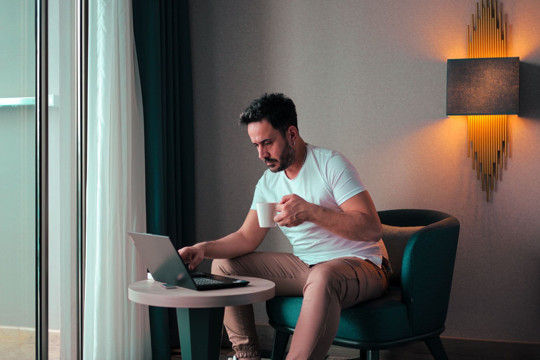 A host reviewing bookings and finances on a laptop at a cozy stay