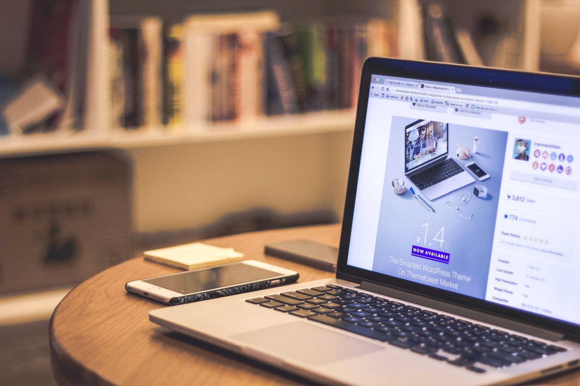 A laptop displaying a website in a cozy modern workspace