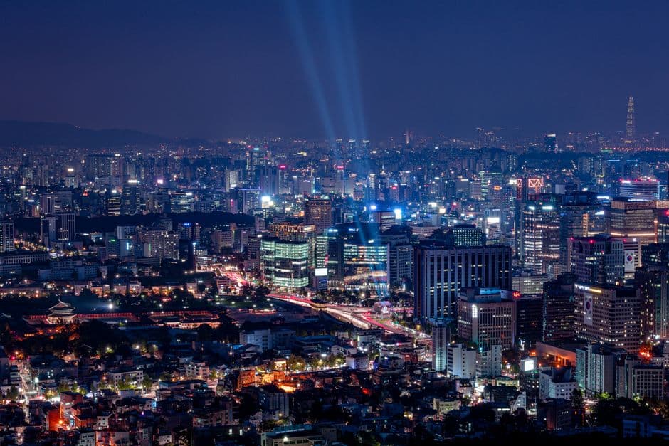 A breathtaking aerial view of a vibrant city illuminated at night.